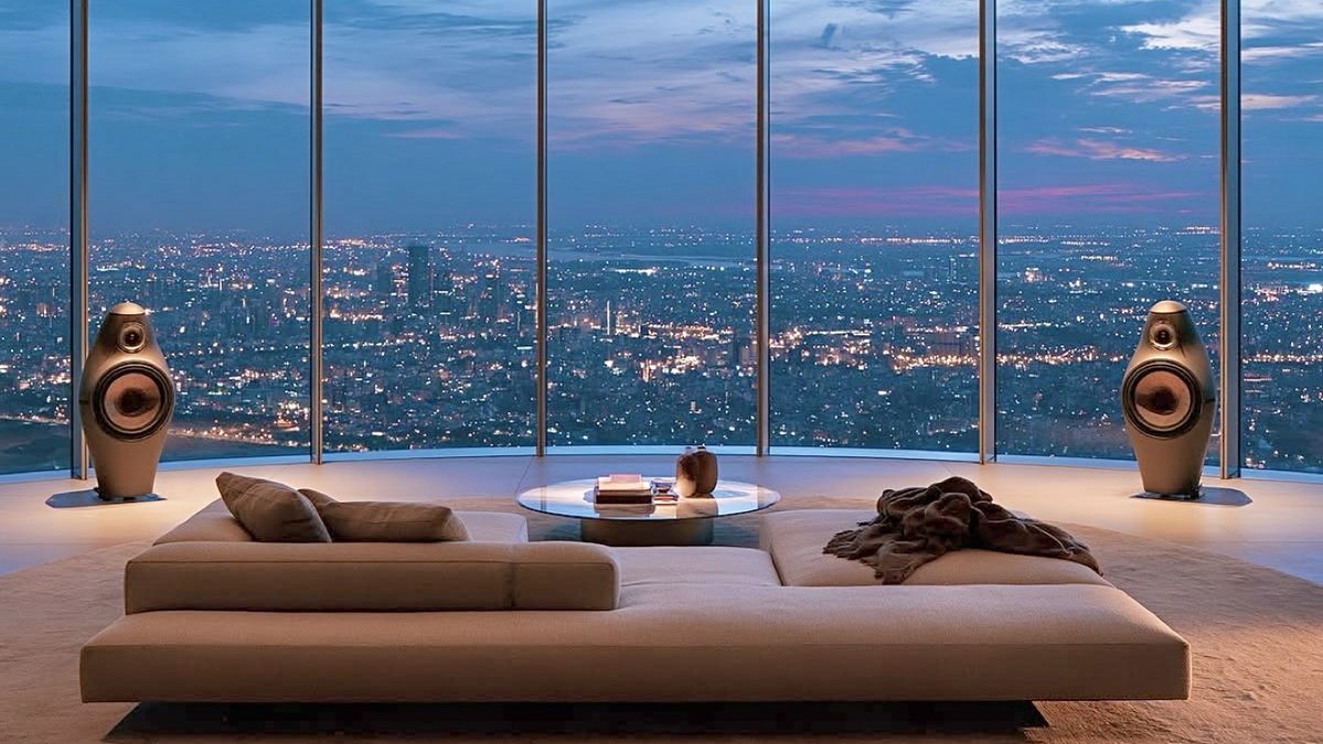 Penthouse living room overlooking the city at dusk