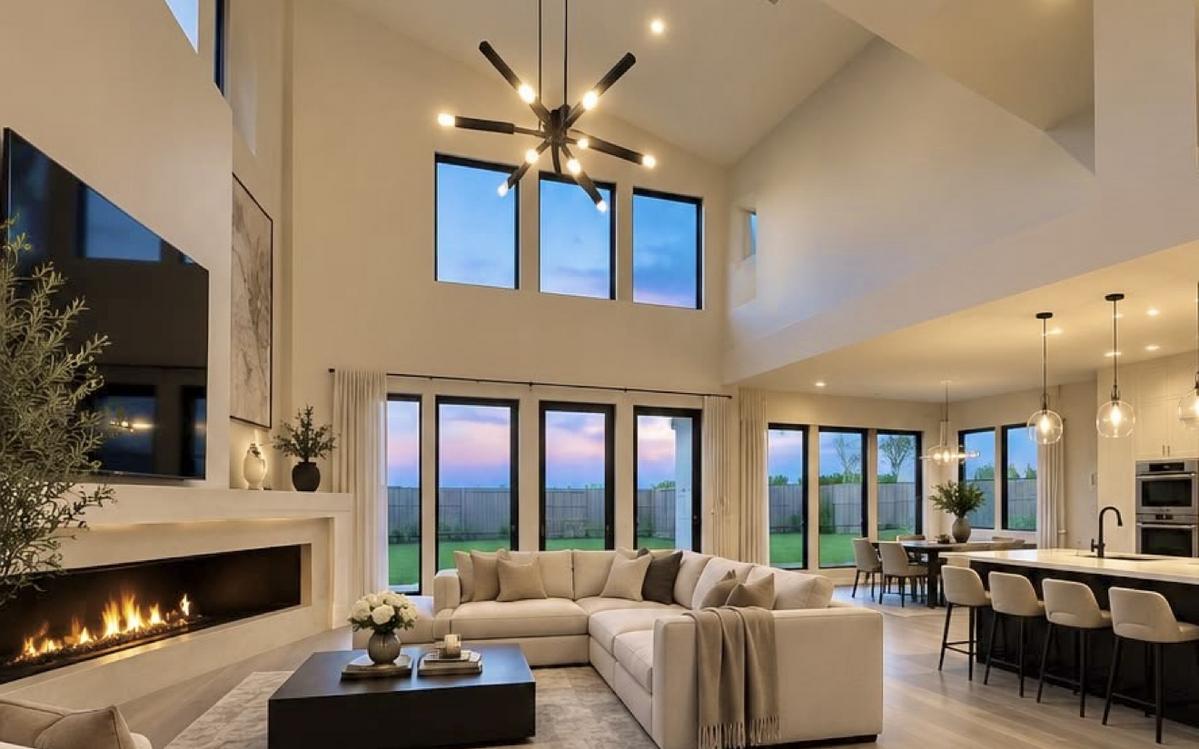 Double-height living room with tall windows and a sectional sofa